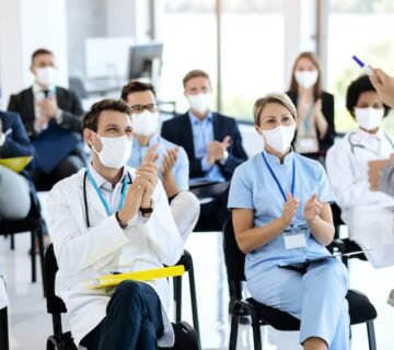 Healthcare workers business people wearing face masks applauding seminar 637285 9140 360x320